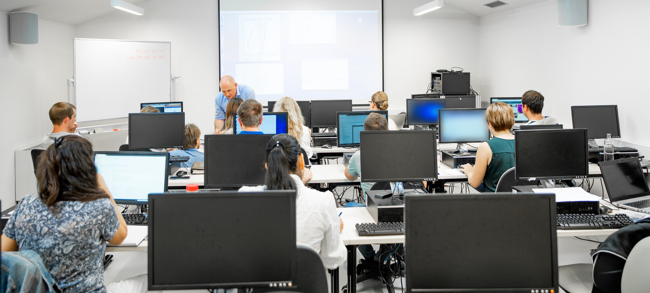Adult Students Using Computers in Classroom
